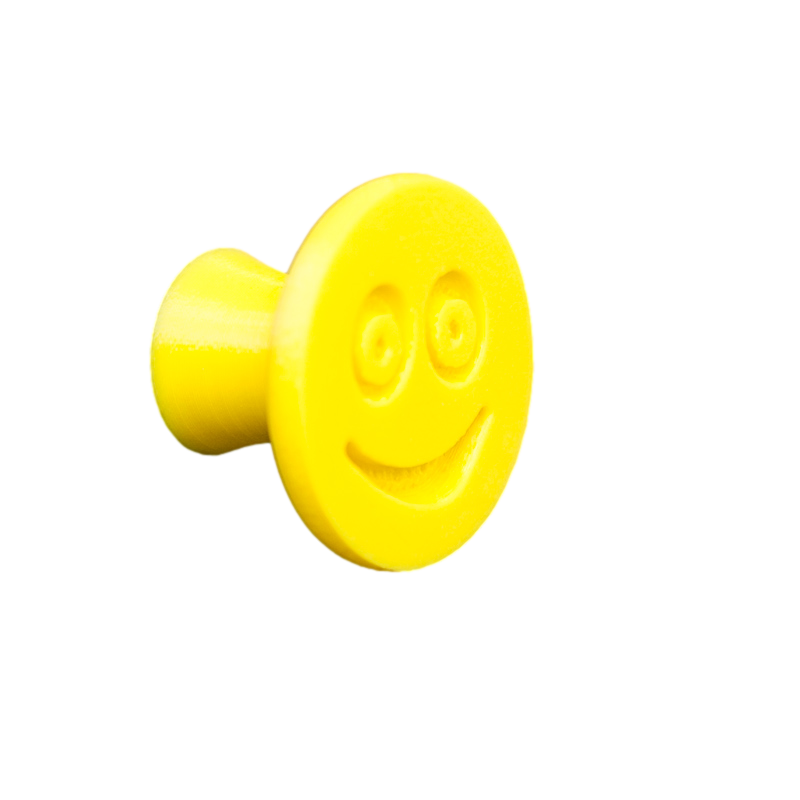 Flexible furniture knob with smile, yellow without background.