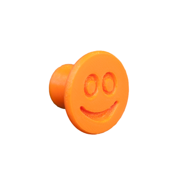 Flexible furniture knob with smile, orange, without background.