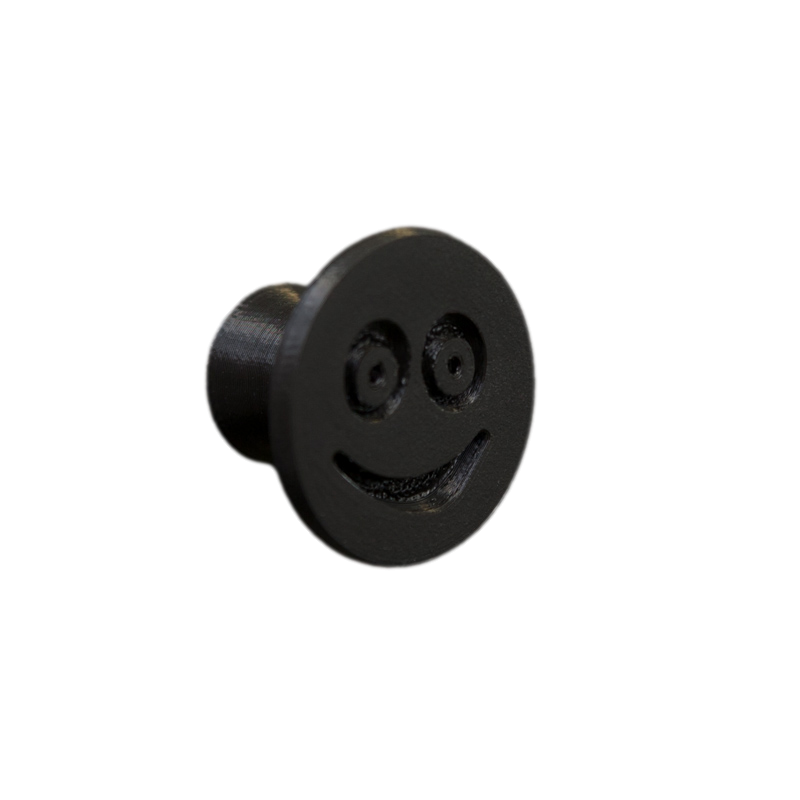 Elastyczna gałka meblowa z uśmiechem, czarna, bez z tła.